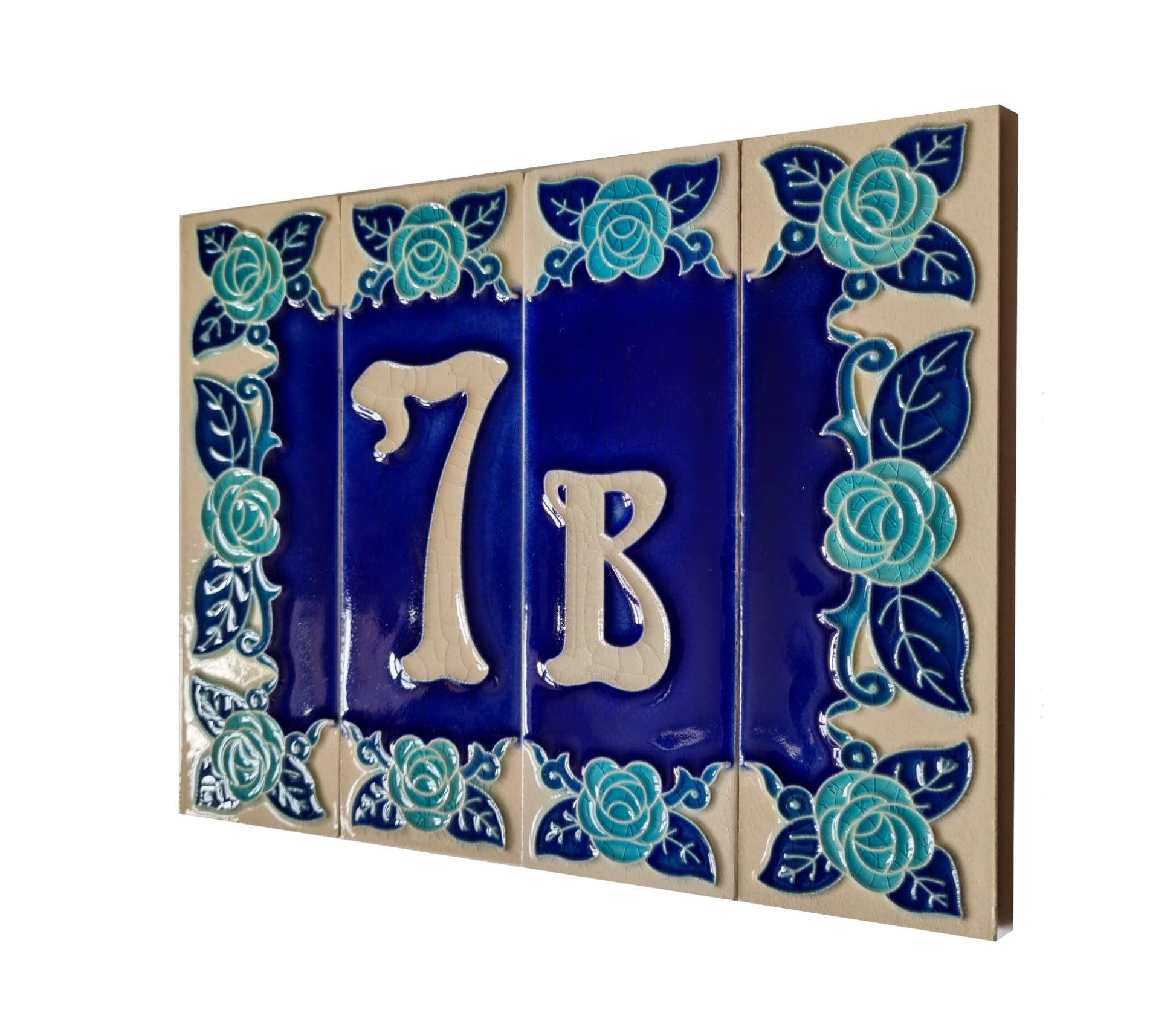 Ceramic house number tile with '7B' and decorative blue roses on a white background
