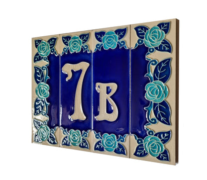 Ceramic house number tile with '7B' and decorative blue roses on a white background