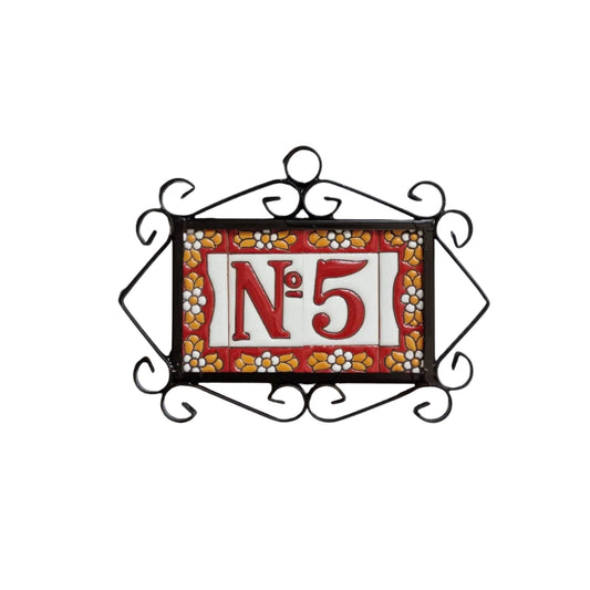 Decorative house number sign with 'No. 5' on a red background, framed by black metalwork.
