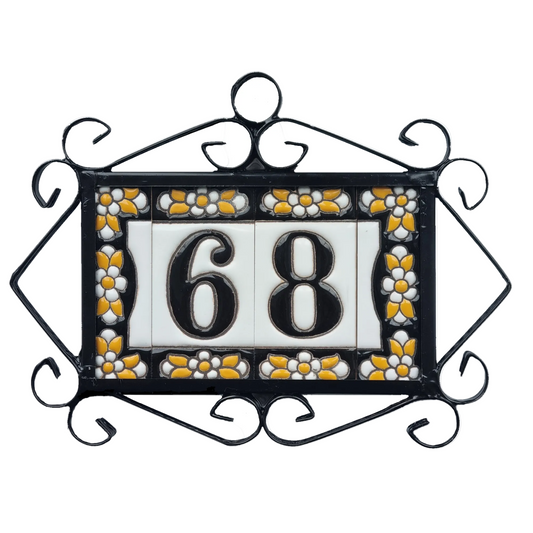 Decorative house number sign with '68' in a floral frame on a white background